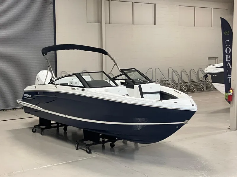 Slide: The Image of 2025 Cobalt R4 Outboard boat displayed indoors, featuring sleek design and modern features. - 2