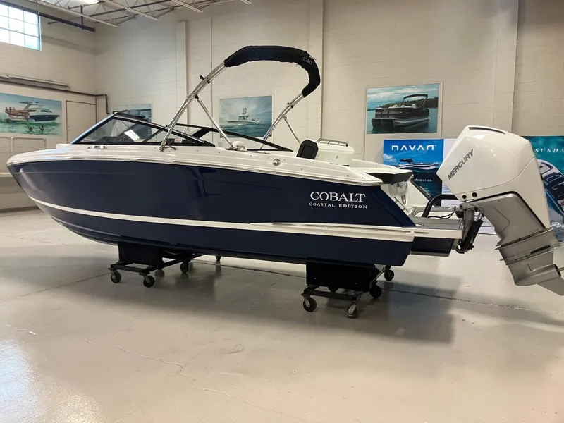 Slide: The Image of 2025 Cobalt R4 Outboard boat in showroom, featuring sleek design and modern outboard engine. - 5