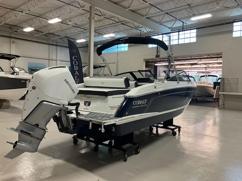 Slide: The Image of 2025 Cobalt R4 Outboard boat in showroom, featuring sleek design and powerful engine. - 6