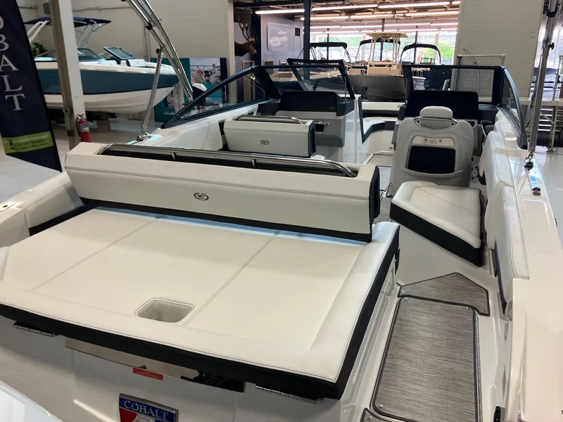 Slide: The Image of 2025 Cobalt R4 Outboard boat interior with white seating and modern design. - 7
