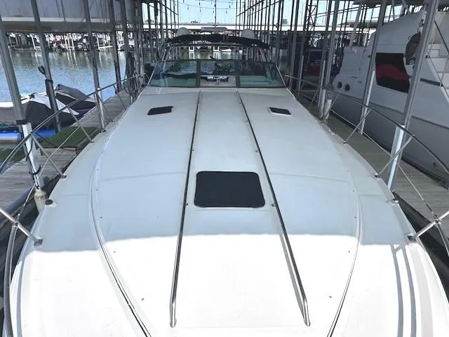 Slide: The Image of 1995 Sea Ray 400 Express Cruiser docked in a marina, top view. - 12