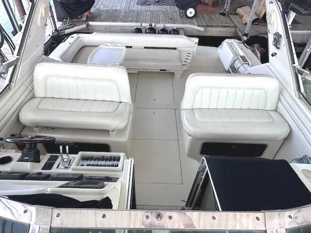 Slide: The Image of 1995 Sea Ray 400 Express Cruiser interior with white seating and control panel. - 13
