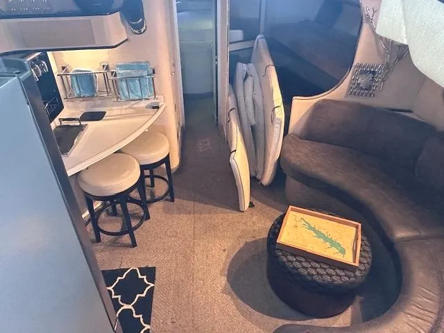 Slide: The Image of Interior of 1995 Sea Ray 400 Express Cruiser with seating and kitchenette. - 15