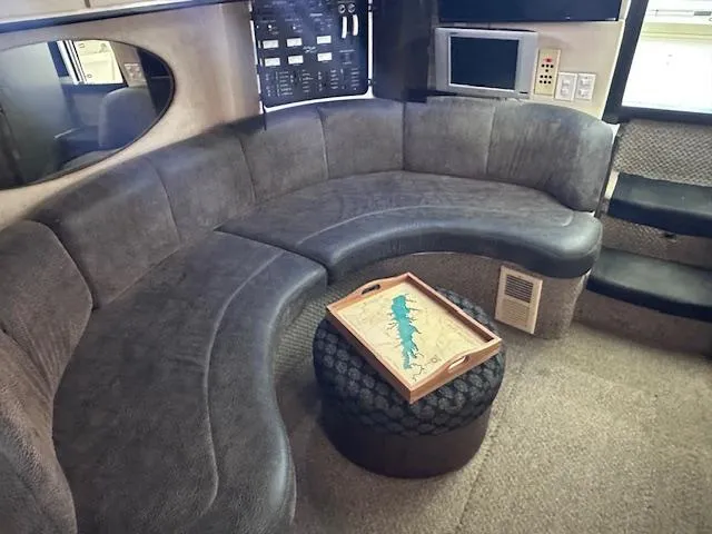 Slide: The Image of Luxurious interior of 1995 Sea Ray 400 Express Cruiser with curved seating and modern amenities. - 16