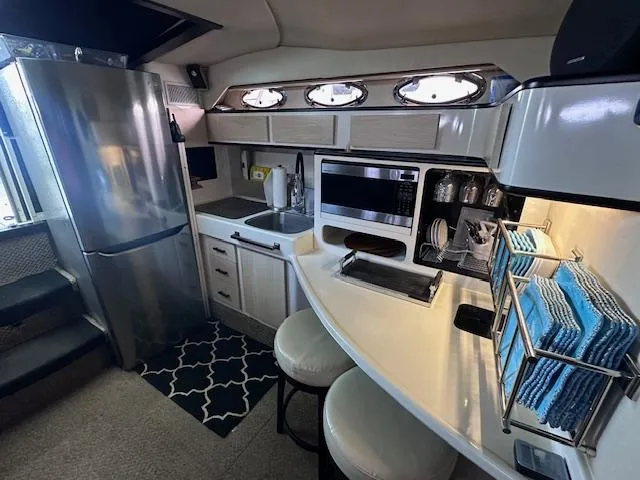 Slide: The Image of Interior of 1995 Sea Ray 400 Express Cruiser with modern kitchen amenities. - 17