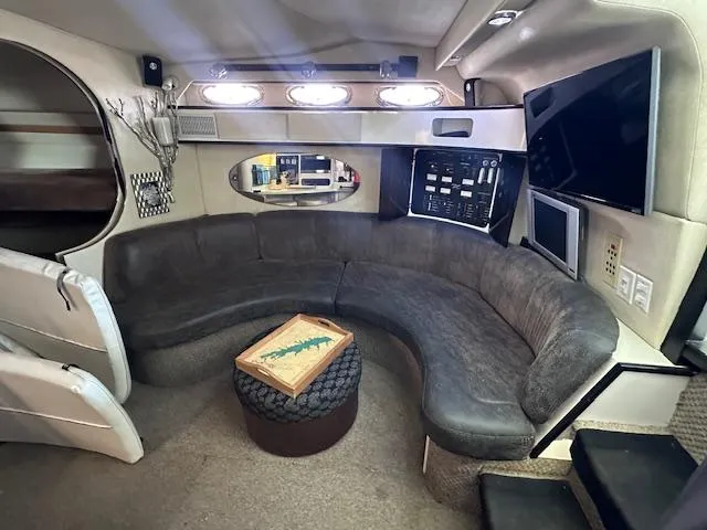 Slide: The Image of Interior of 1995 Sea Ray 400 Express Cruiser with curved seating and modern amenities. - 19