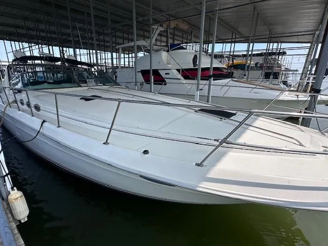 Slide: The Image of 1995 Sea Ray 400 Express Cruiser docked in a covered marina. - 2