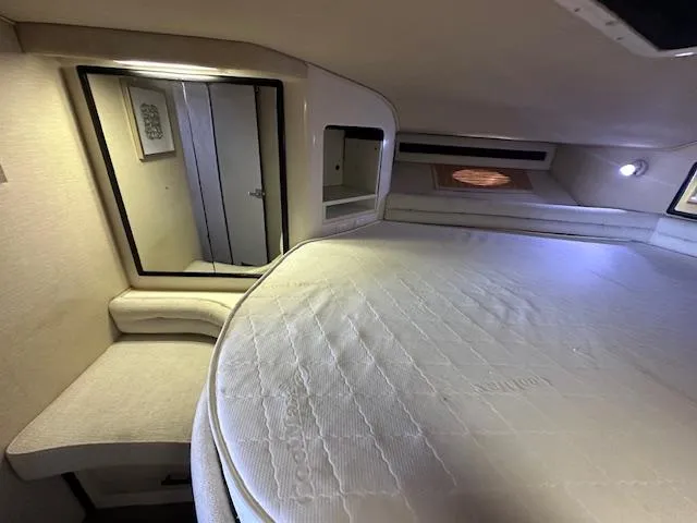 Slide: The Image of Interior cabin of 1995 Sea Ray 400 Express Cruiser with bed and mirror. - 23