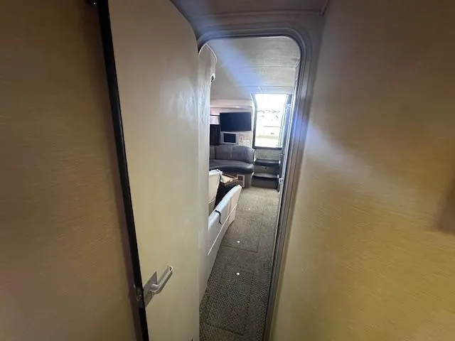 Slide: The Image of Interior view of 1995 Sea Ray 400 Express Cruiser, showing cozy cabin and seating area. - 24