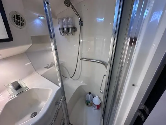 Slide: The Image of 1995 Sea Ray 400 Express Cruiser bathroom with shower, sink, and toiletries. - 27