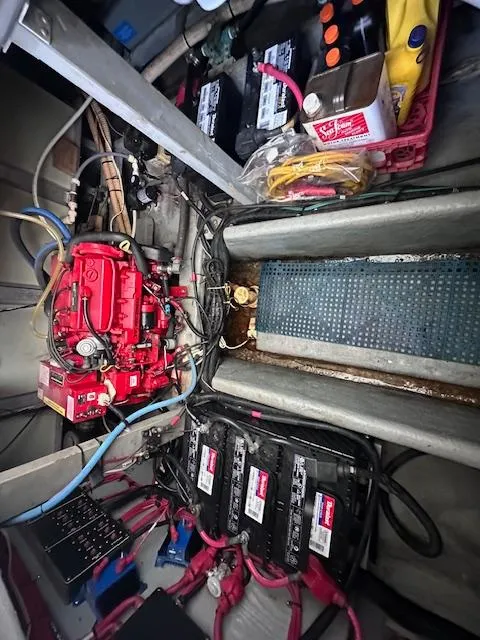 Slide: The Image of Engine compartment of a 1995 Sea Ray 400 Express Cruiser with batteries and wiring. - 28