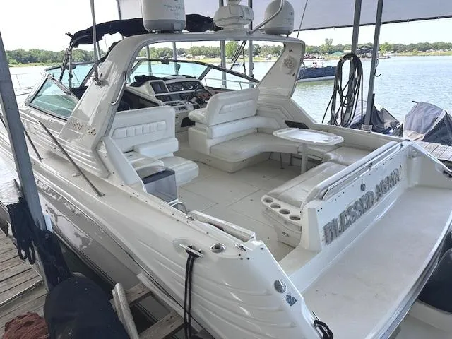 Slide: The Image of 1995 Sea Ray 400 Express Cruiser docked, featuring spacious seating and sleek design. - 3