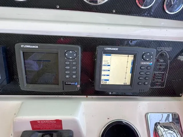Slide: The Image of Control panel of a 1995 Sea Ray 400 Express Cruiser with Lowrance navigation displays. - 34