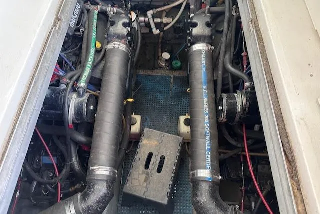 Slide: The Image of Engine compartment of a 1995 Sea Ray 400 Express Cruiser with visible hoses and components. - 36
