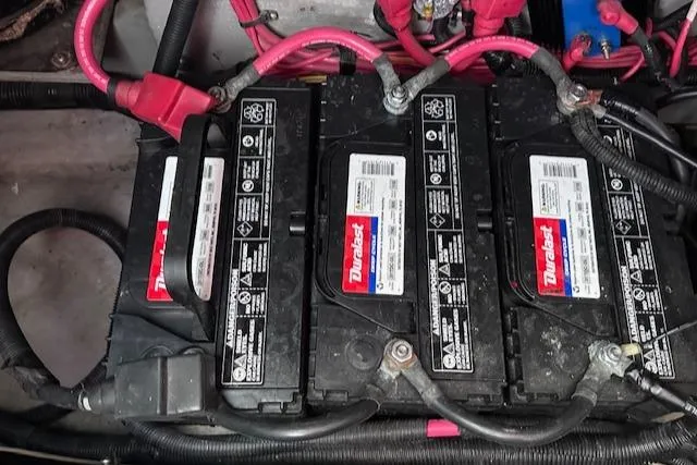Slide: The Image of Batteries in a 1995 Sea Ray 400 Express Cruiser with connected cables. - 39