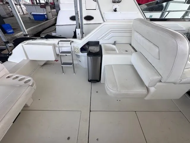 Slide: The Image of 1995 Sea Ray 400 Express Cruiser interior with white seating and ladder. - 8