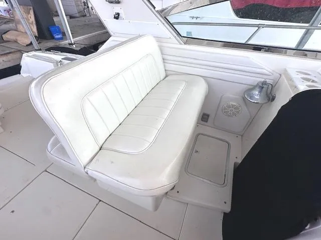 Slide: The Image of 1995 Sea Ray 400 Express Cruiser interior with white seating and speaker. - 9