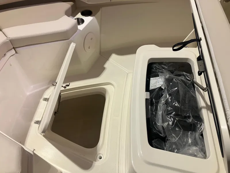 Slide: The Image of 2025 Boston Whaler 250 Outrage boat storage compartments and seating area. - 12