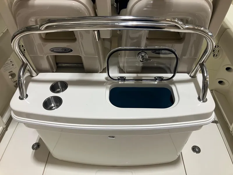 Slide: The Image of 2025 Boston Whaler 250 Outrage boat console with cup holders and storage compartment. - 4