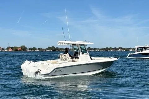 Slide: The Image of 2025 Boston Whaler 250 Outrage cruising on a sunny day in open water. - 40