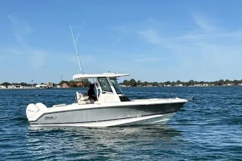 Slide: The Image of 2025 Boston Whaler 250 Outrage boat cruising on a sunny day. - 42