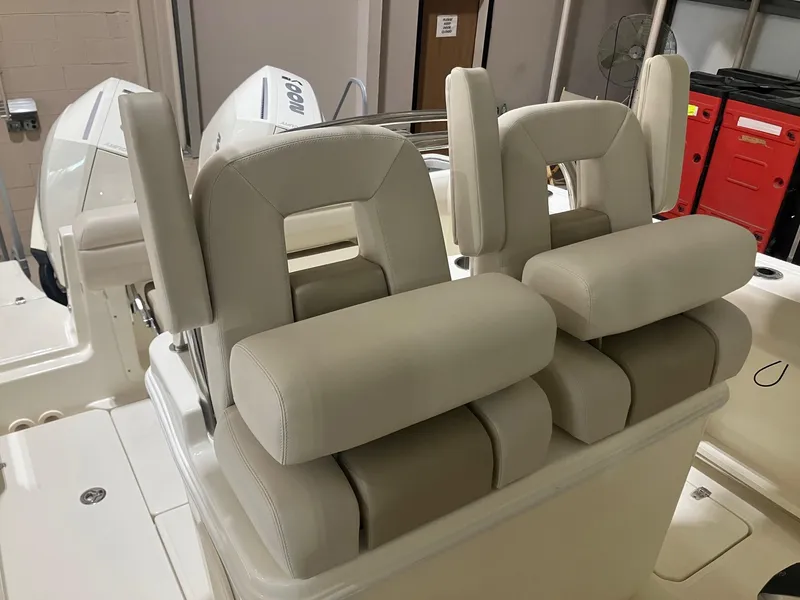 Slide: The Image of 2025 Boston Whaler 250 Outrage boat seats, featuring plush, beige upholstery and ergonomic design. - 5