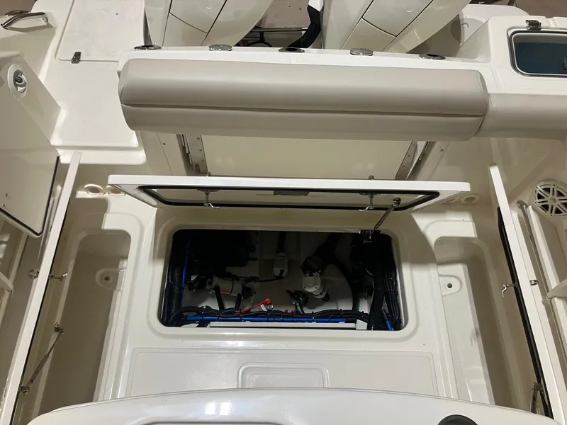 Slide: The Image of 2025 Boston Whaler 250 Outrage boat interior, showcasing open storage compartment and seating area. - 8