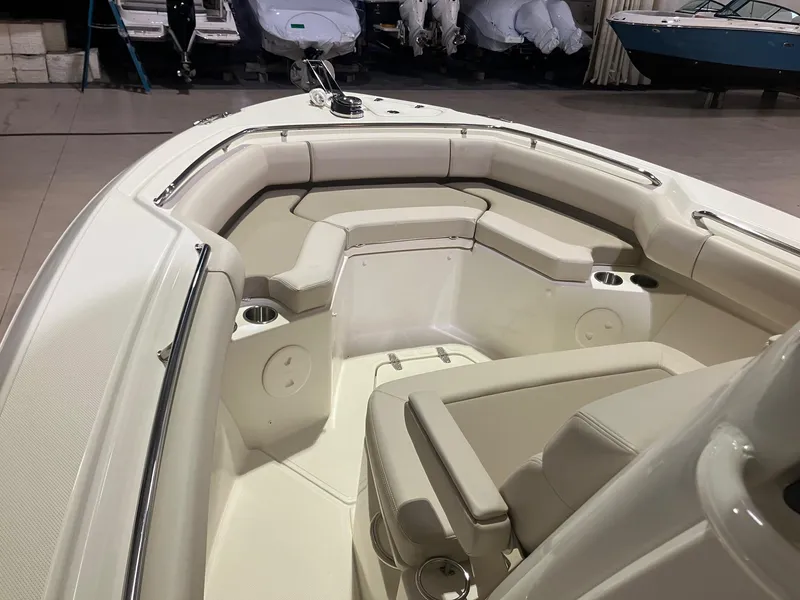 Slide: The Image of 2025 Boston Whaler 250 Outrage boat interior with cushioned seating and cup holders. - 9