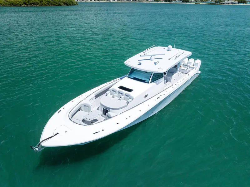 Slide: The Image of 2025 HCB 56' Sueños GIX luxury yacht cruising on clear turquoise waters. - 10