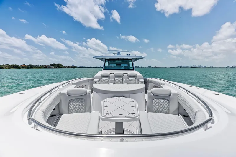 Slide: The Image of 2025 HCB 56' Sueños GIX luxury yacht on open water, clear sky background. - 19