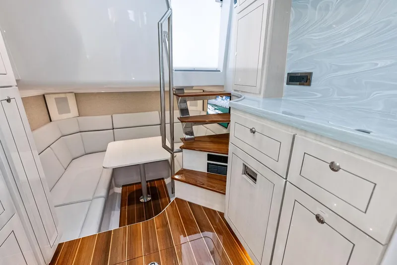 Slide: The Image of Luxurious interior of 2025 HCB 56' Sueños GIX yacht with elegant seating and wooden flooring. - 45