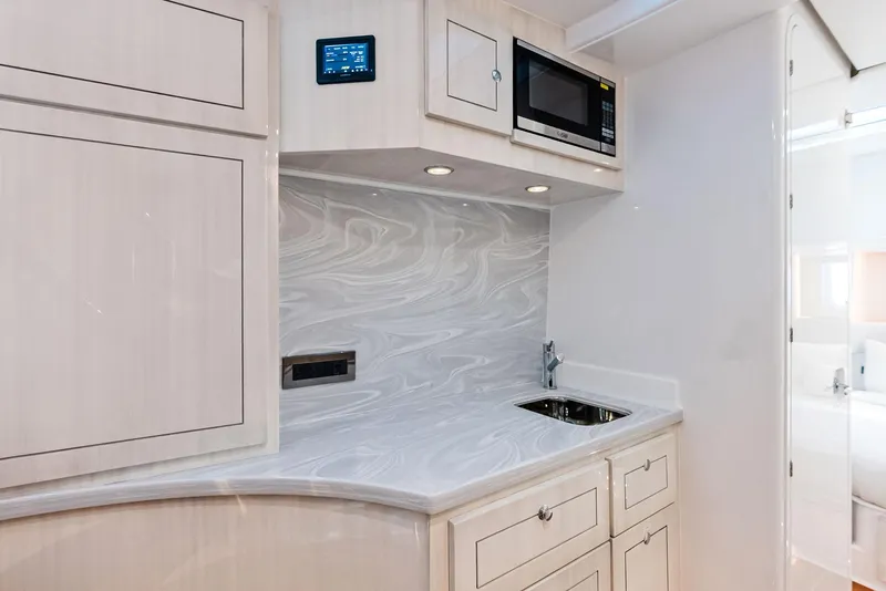 Slide: The Image of Modern kitchenette in 2025 HCB 56' Sueños GIX yacht with sleek cabinetry and appliances. - 46