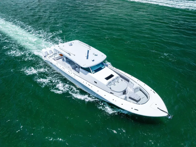 Slide: The Image of 2025 HCB 56' Sueños GIX luxury yacht cruising on open water. - 6