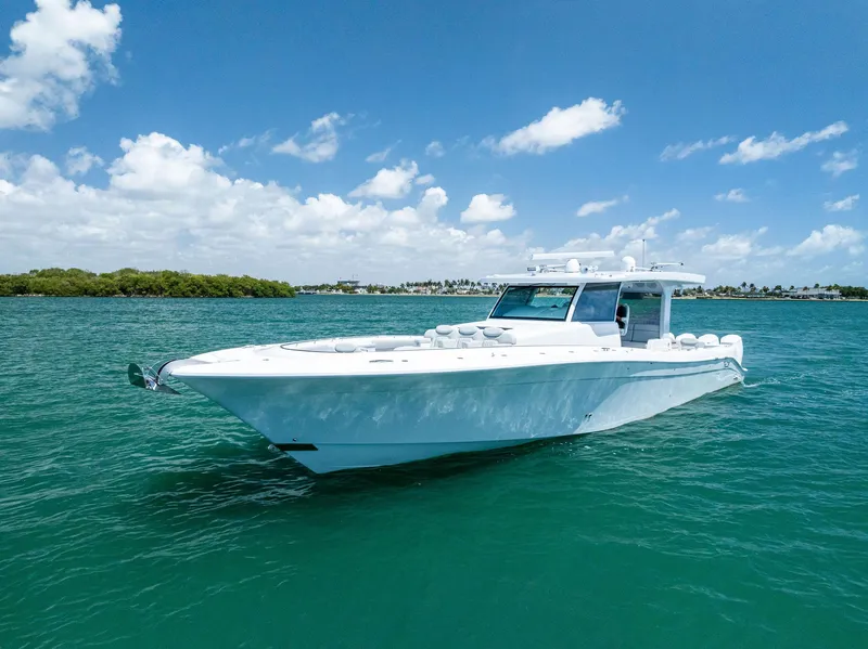 Slide: The Image of 2025 HCB 56' Sueños GIX luxury yacht cruising on clear blue water. - 7