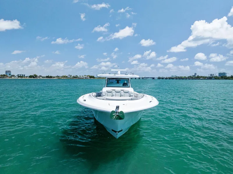 Slide: The Image of 2025 HCB 56' Sueños GIX yacht on clear blue water under a sunny sky. - 8