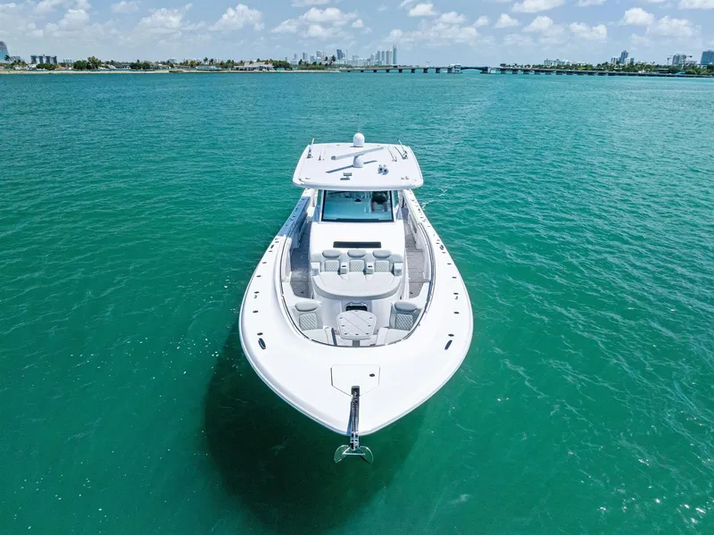 Slide: The Image of 2025 HCB 56' Sueños GIX yacht cruising on turquoise waters under a clear sky. - 9