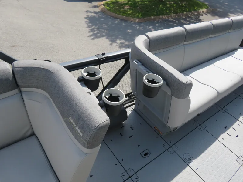 Slide: The Image of 2023 Sea-Doo Switch 230 interior with gray seating and cup holders. - 7