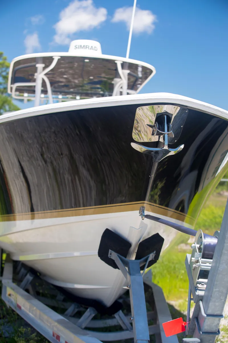 Slide: The Image of 2012 Contender 39 LS boat on trailer under clear blue sky. - 2
