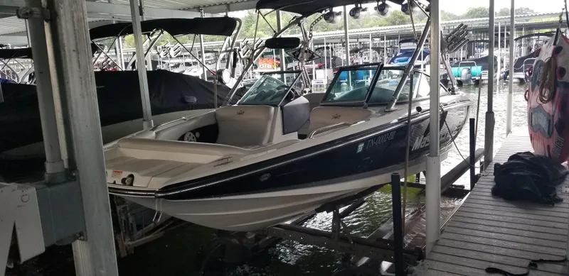 The Image of 2009 MasterCraft X-45 boat docked in a marina, under a covered slip. - 1