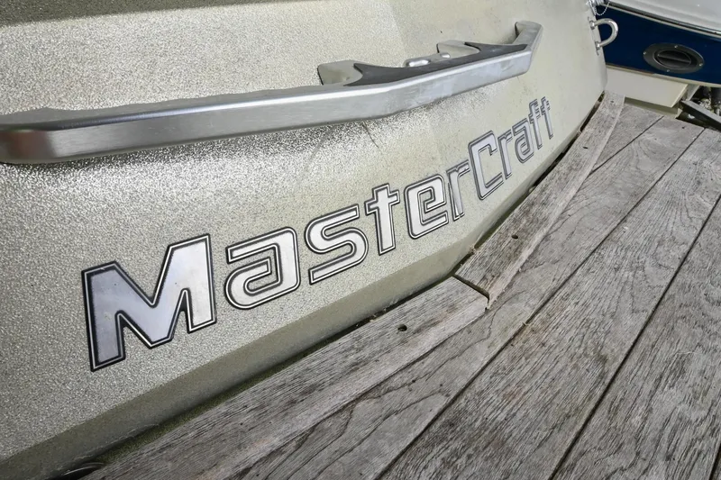 Slide: The Image of 2009 MasterCraft X-45 boat on wooden dock, close-up of logo. - 11