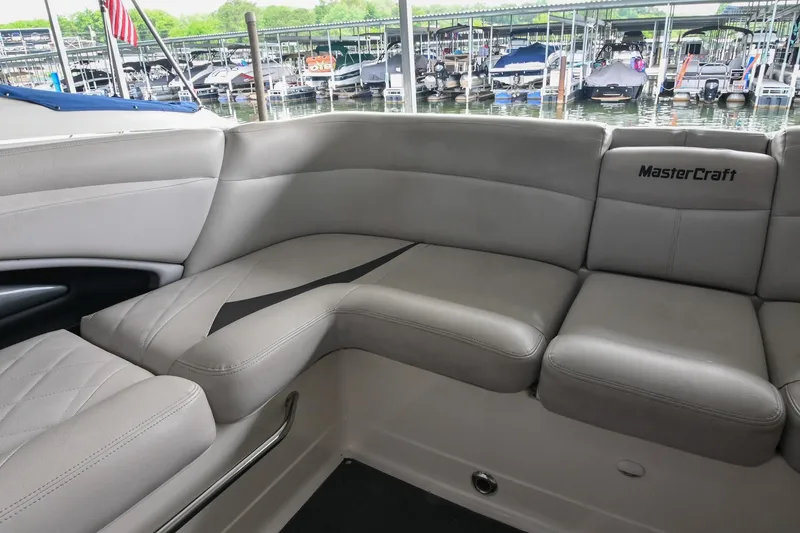 Slide: The Image of Luxurious seating on a 2009 MasterCraft X-45 boat, docked at a marina. - 19
