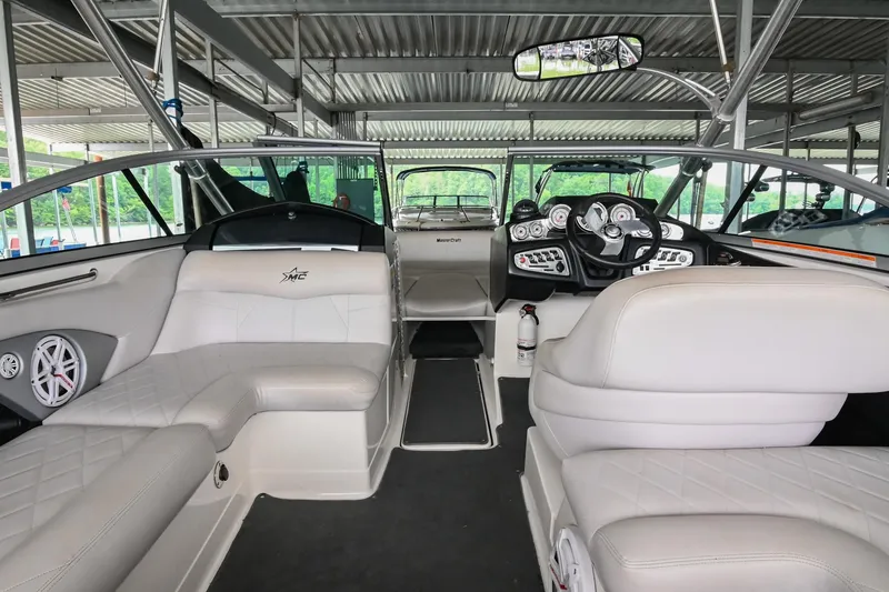 Slide: The Image of Interior of a 2009 MasterCraft X-45 boat with luxurious seating and modern dashboard. - 24