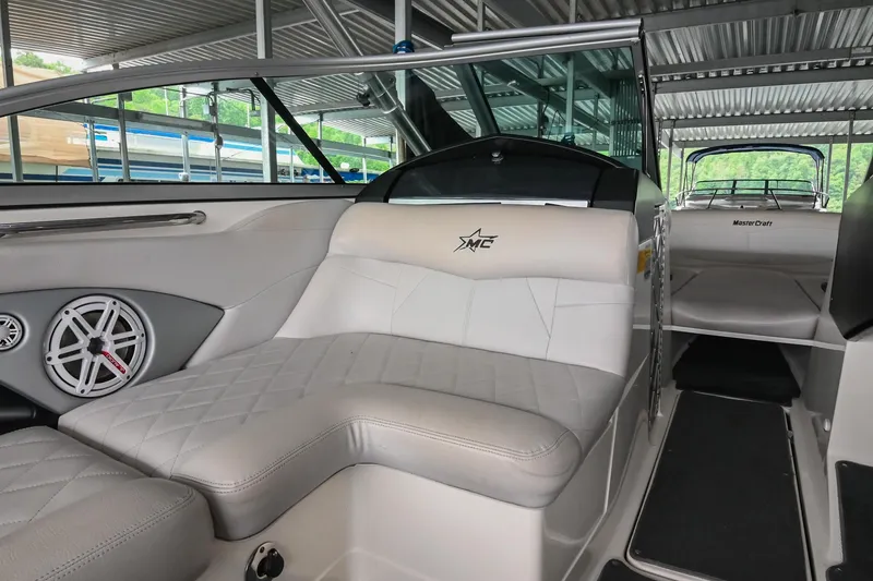 Slide: The Image of 2009 MasterCraft X-45 boat interior with white leather seating and speaker system. - 25