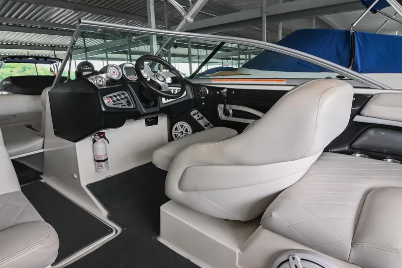 Slide: The Image of 2009 MasterCraft X-45 boat interior with steering wheel and seating. - 27