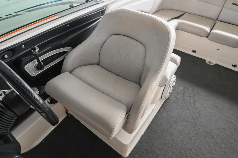 Slide: The Image of 2009 MasterCraft X-45 boat interior with plush captain's chair and steering wheel. - 33