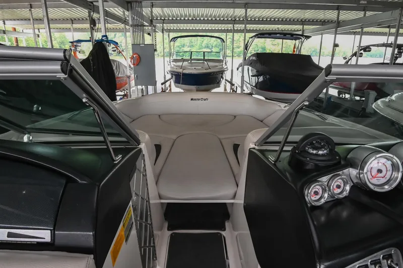 Slide: The Image of 2009 MasterCraft X-45 boat interior with dashboard and seating in a covered dock. - 34