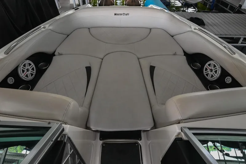 Slide: The Image of 2009 MasterCraft X-45 boat interior with white cushioned seating and built-in speakers. - 35