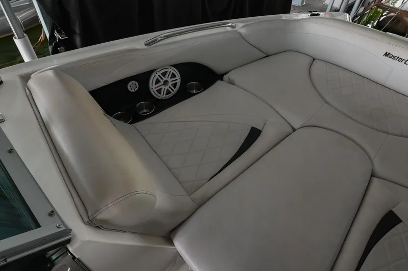 Slide: The Image of 2009 MasterCraft X-45 boat interior with cushioned seating and speaker system. - 36