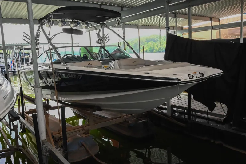 Slide: The Image of 2009 MasterCraft X-45 boat docked under a covered marina. - 4