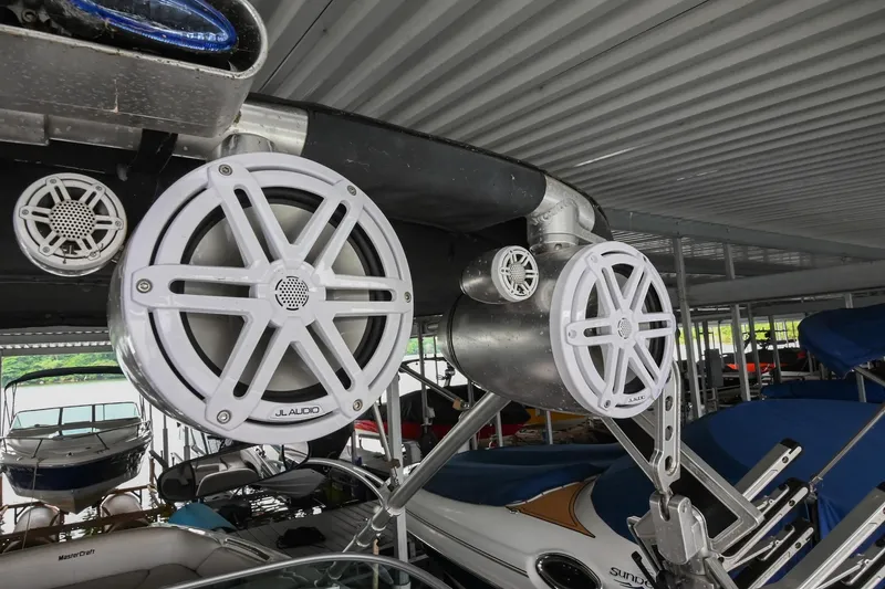 Slide: The Image of 2009 MasterCraft X-45 boat with mounted speakers in a covered dock. - 44
